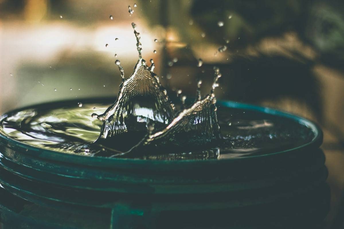 Water dripping into a bucket from a leak